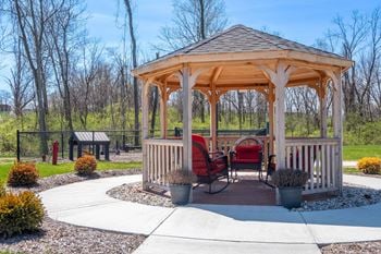 A gazebo with a table and chairs